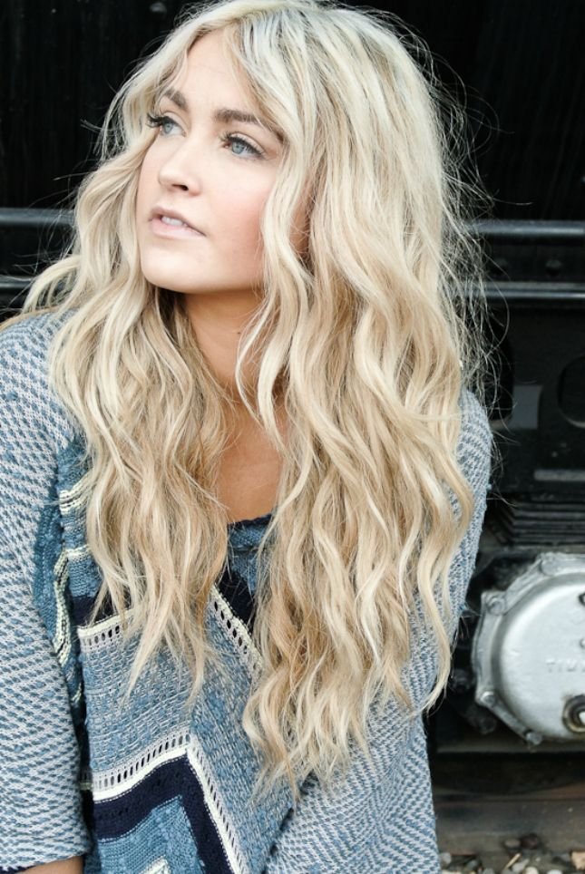 Long beach blonde hair with curled out edges to resemble a windblown look